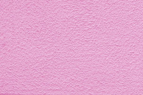 Pink plaster wall of a building. Rough surface texture.  - Photo, Image