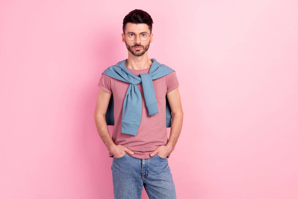 Photo of serious handsome man wear glasses hold hands pockets jeans isolated on pink color background - Φωτογραφία, εικόνα