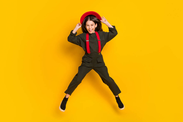Full length body size view of attractive cheerful funky girl jumping having fun isolated over bright yellow color background - Фото, зображення