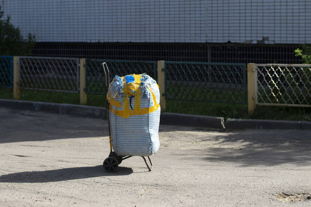 A bag on a trolley. Forgotten suspicious bag. A trolley on wheels with things. - Foto, Imagem