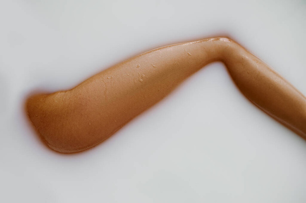 Sexy woman lying in bath with milk, view on leg - Fotoğraf, Görsel