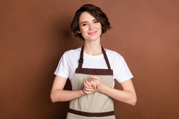 Portrait of attractive cheerful girl store seller welcoming you to new cafe coffee shop isolated over brown color background - Φωτογραφία, εικόνα