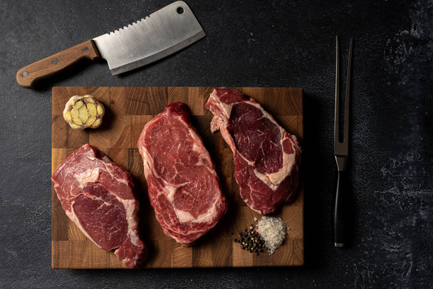 Raw marbled beef steak on a wooden cutting board - Fotografie, Obrázek
