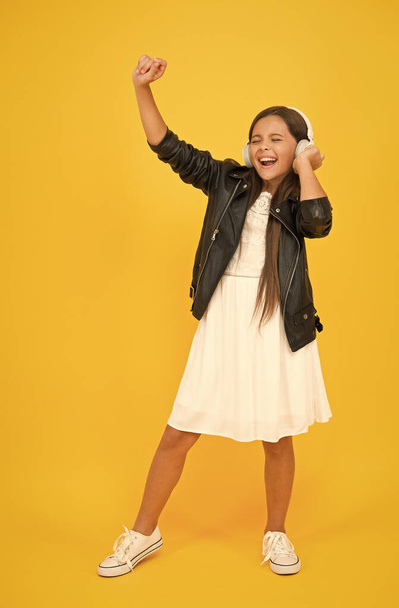 this is my day. future pop star. child enjoying rhythms. be creative and active. full of energy. happy kid singing. listen to music. little girl with headphones. child having fun. childhood happiness - Foto, Bild