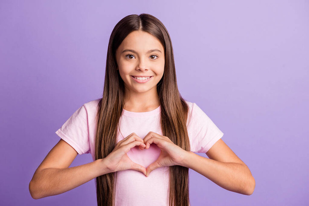 Photo of young girl happy positive smile show fingers heart sign feelings valentine day isolated over violet color background - Foto, imagen