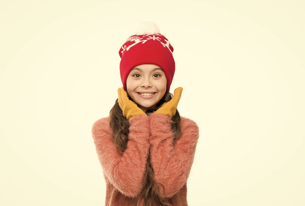 care of knitwear. small girl in knitted hat and gloves. xmas holiday activity. child cosy sweater isolated on white. cold winter weather. warm clothes and accessory fashion for kids. happy childhood - Foto, afbeelding