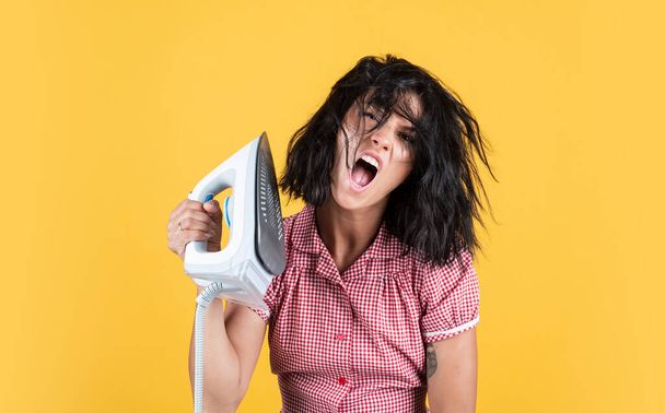 happy pretty woman with brunette hair use steaming iron, housekeeping - Foto, afbeelding
