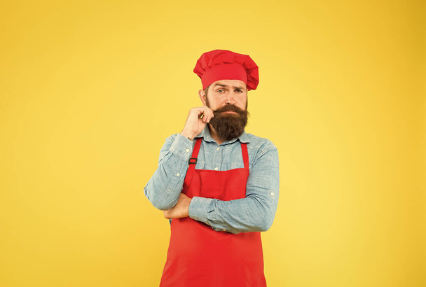 Committed to good food. mature hipster with serious face. satisfied bearded chef. brutal butcher in apron. best menu offer. confident bearded happy chef white uniform. Male chef in red uniform - 写真・画像