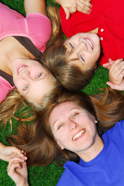 Family lying down on grass - Photo, Image