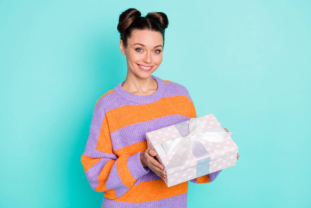 Portrait of satisfied adorable girl hands hold giftbox beaming smile wear pullover isolated on blue color background - Фото, изображение