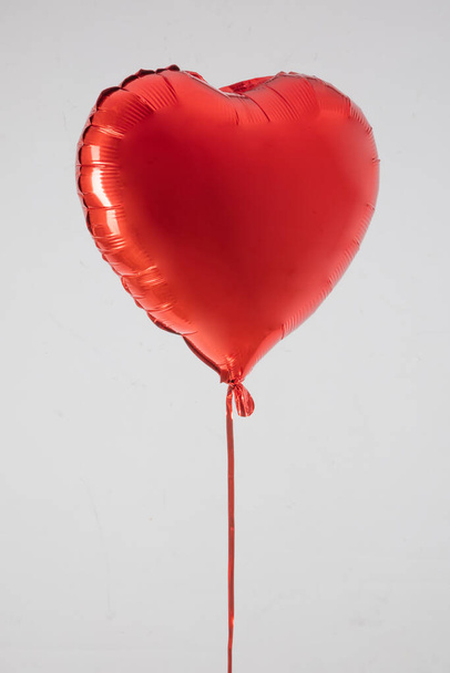 Air Balloon Set. Bunch of red color heart shaped foil balloons isolated on white background. Love. Holiday celebration. Valentine's Day party decoration. Metallic red color Heart air balls. - Φωτογραφία, εικόνα