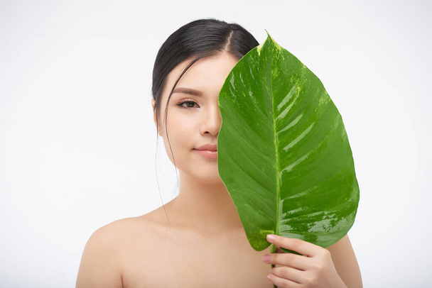 Young Woman with Big Lush Leaf - Photo, Image
