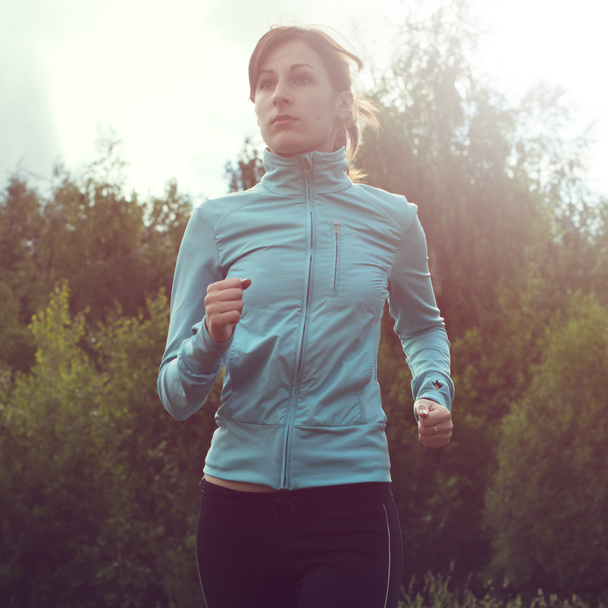 Athlete sportsmen girl running in morning sunrise training for marathon and fitness. Healthy active lifestyle woman exercising outdoors. - Fotografie, Obrázek