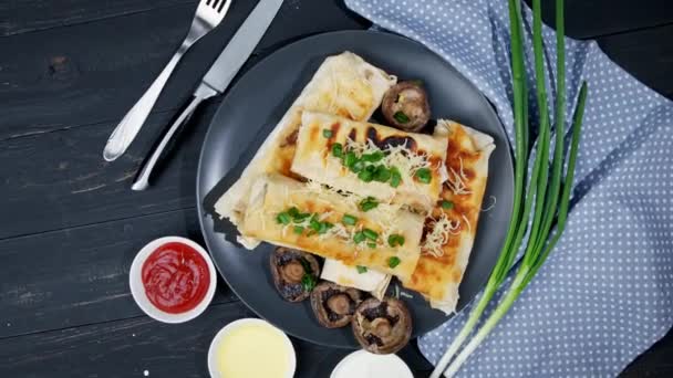 resh roll of thin lavash or lavash stuffed with potatoes, mushrooms, cheese, carrots, sauce, herbs on a plate. - Footage, Video
