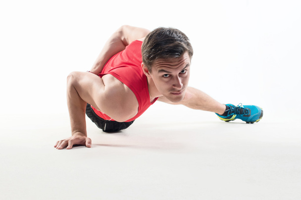 Sexy Young fashion sport muscle man, fitness model guy making push ups one hand exercise - Valokuva, kuva