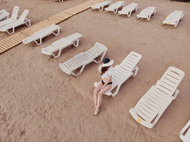 Vacation and adventure. Top view from drone at beach, beach chair and relax girl - Valokuva, kuva