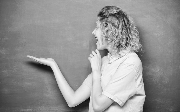 Better than thousand days diligent study is one day with great teacher. Woman teacher in front of chalkboard. Teacher explain hard topic. Important information to remember. Teacher friend of learners - 写真・画像