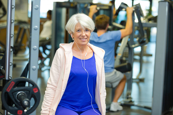 happy senior woman exercising at fitness center - Photo, Image