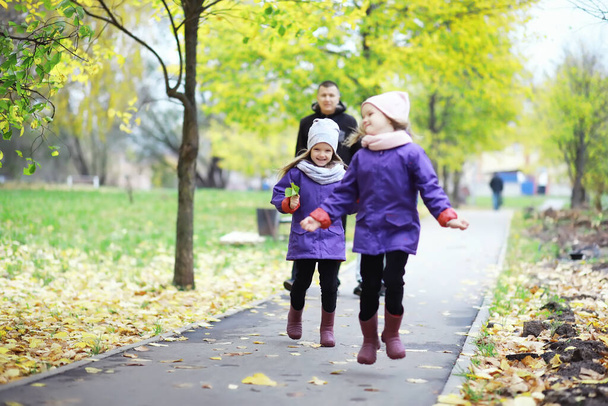 Gyerekek sétálni az őszi parkban. Levél hullik a parkba. Család. Bukj el! Boldogság. - Fotó, kép