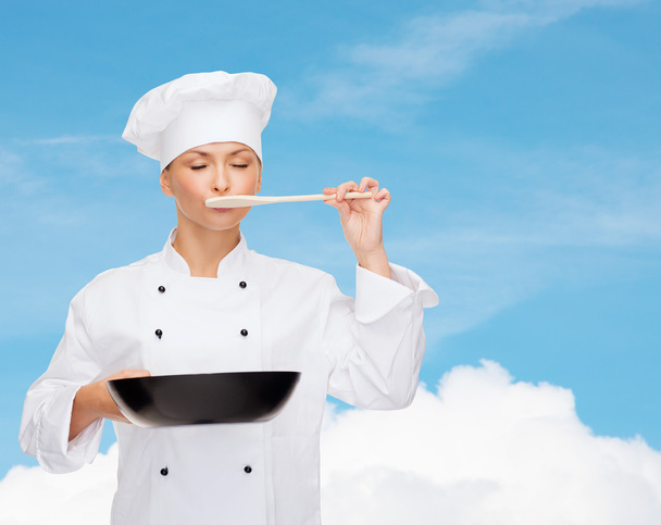 smiling female chef with pan and spoon - Photo, Image