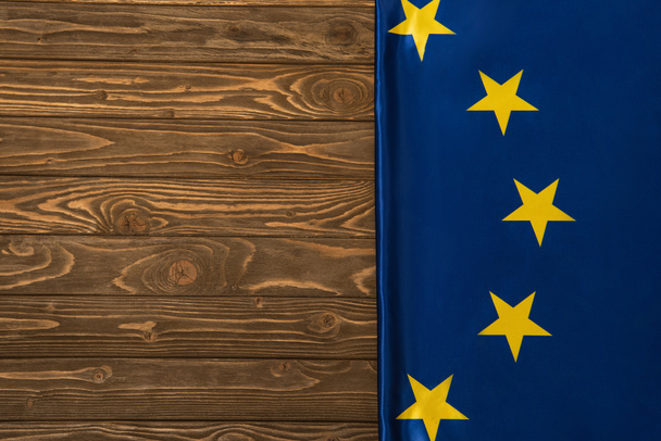 top view of european union flag on wooden surface  - Zdjęcie, obraz