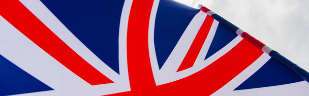 close up view of national flag of united kingdom with red cross against sky, banner - Photo, Image