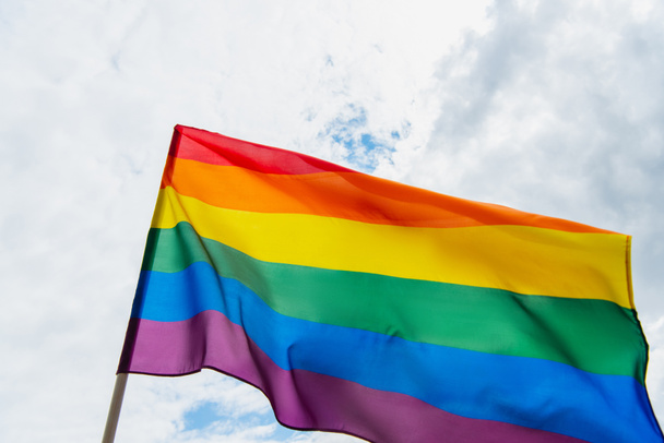 low angle view of colorful lgbt flag against sky with clouds - Fotó, kép