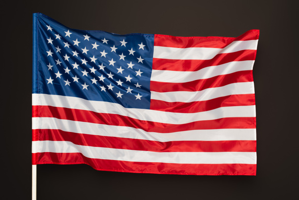 read and blue flag of america with stars and stripes isolated on black - Photo, Image