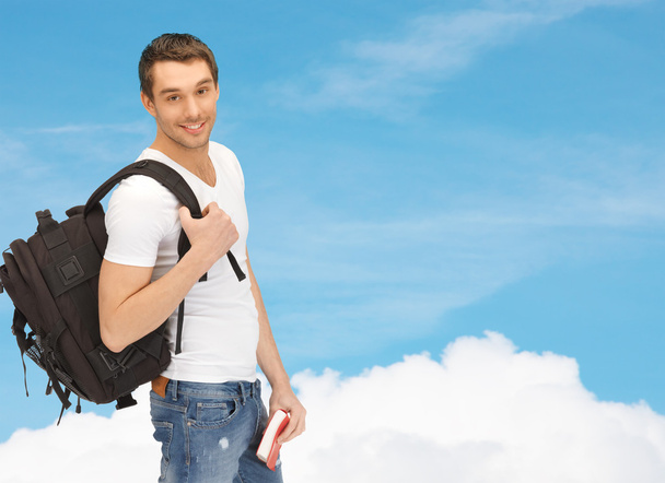 travelling student with backpack and book - Foto, afbeelding