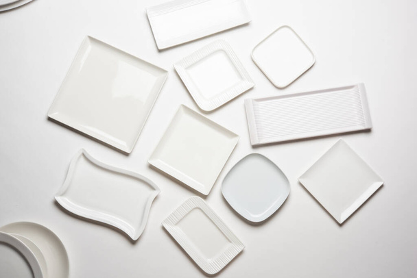 piastre bianche di forma diversa isolate su sfondo bianco, vista dall'alto - Foto, immagini