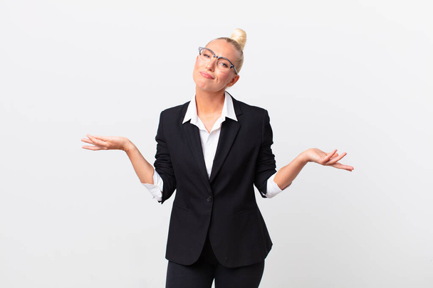 pretty blond woman feeling puzzled and confused and doubting. business concept - Photo, Image