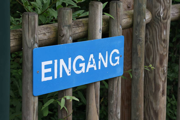 Sign on a wooden fence in German - Entrance - Photo, Image