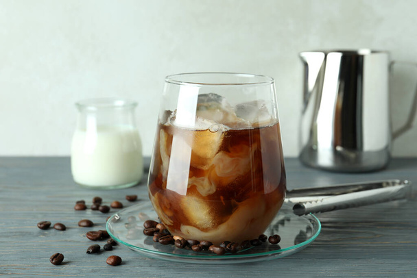 Concept of cold drink with ice coffee on wooden table - Fotoğraf, Görsel