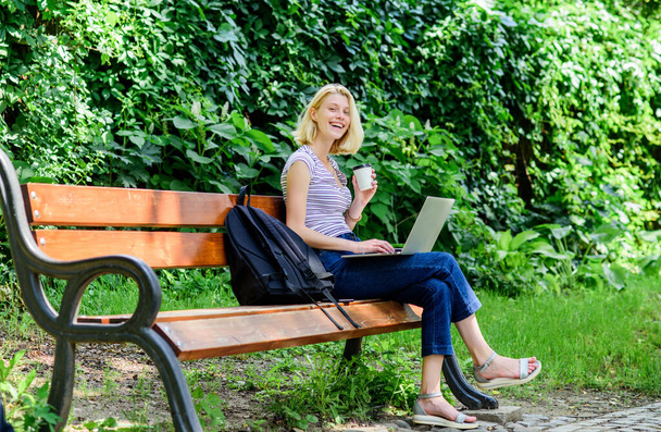 girl work on laptop. modern woman with computer outdoor. summer online. Morning chart. girl drink coffee to go. Relax in park. Pretty woman drinking takeaway coffee. Smart and confident student - Фото, зображення
