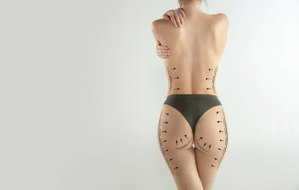 Slim beautiful female body in underwear over light background. Beauty fitness concept. - Valokuva, kuva