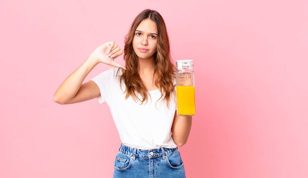 young pretty woman holding an orange juice - Zdjęcie, obraz