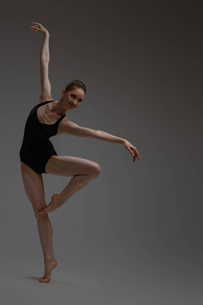 Happy ballet dancer staying on one leg - 写真・画像