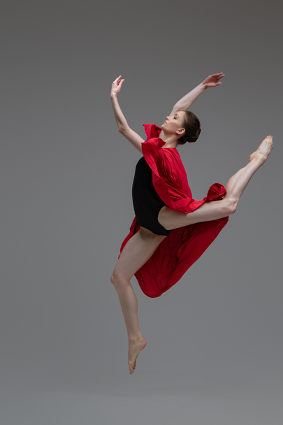Professional ballet dancer with red silk inside studio - Photo, Image