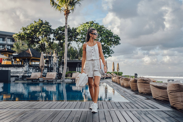 Shot of stylish woman posing around swimming pool - Zdjęcie, obraz