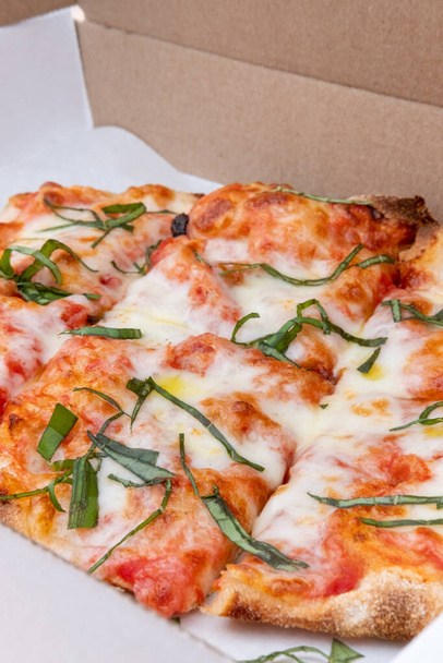 Italian pizza margarita on thin crust in a box - Fotoğraf, Görsel