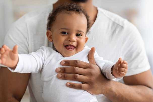 Closeup Portrait Of Adorable Black Baby Boy Relaxing In Fathers Hands - Photo, Image