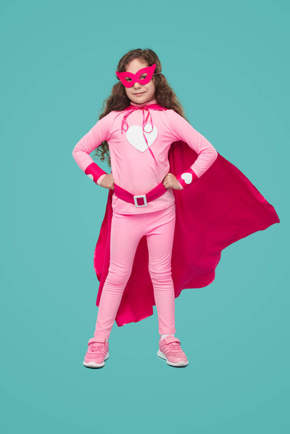 Confident youngster in pink superhero costume - Fotó, kép