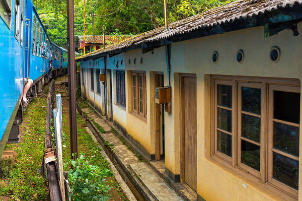 Traveling around the island of Sri Lanka by train. Residential buildings are close to the railroad. Terrible living conditions. - Фото, изображение