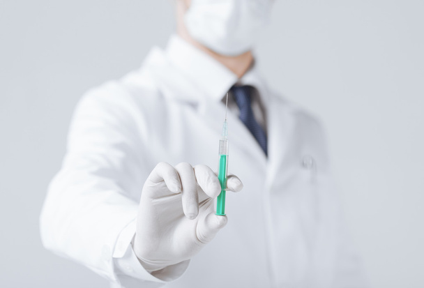 male doctor holding syringe with injection - 写真・画像