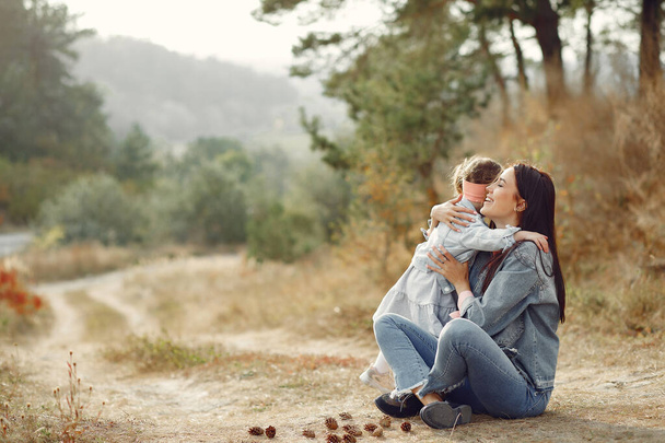 Mother with little daughter playing in a autumn field - Photo, Image