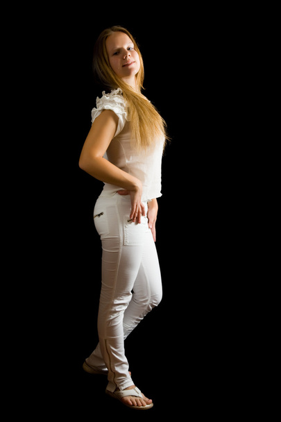 Isolated full length view of girl in white jeans over black - 写真・画像