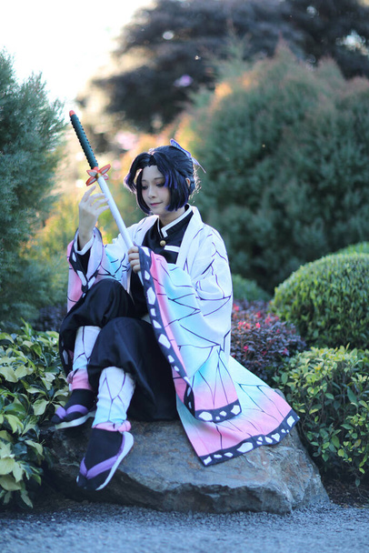 Japan anime cosplay portrait of girl with comic costume with japanese theme garden - Photo, Image
