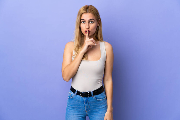 Young Uruguayan blonde woman over isolated background showing a sign of silence gesture putting finger in mouth - Foto, Imagem