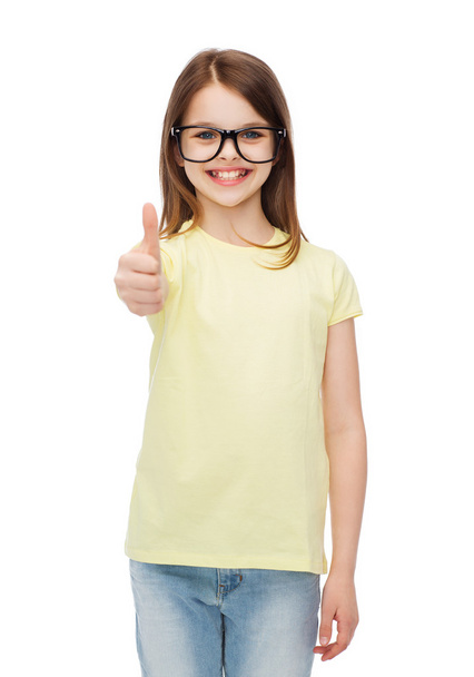 smiling cute little girl in black eyeglasses - 写真・画像