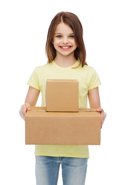 smiling little girl with many cardboard boxes - 写真・画像